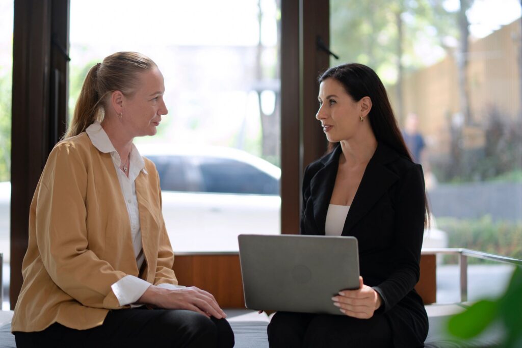 People in white collar jobs are meeting together in the lobby of a hotel.